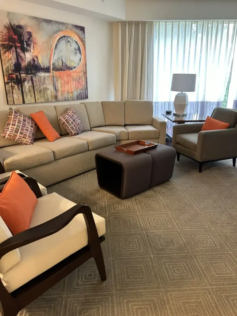 Spacious living room with sectional sofa and modern art at Marriott Imperial Palms Villa near Disney World