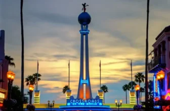 Disney Hollywood Studios Crossroads entrance at sunset with palm trees