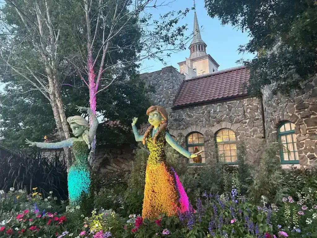 EPCOT Guide: Best Rides, Food & World Showcase Tips 2 Anna and Elsa Frozen flower topiaries in the Norway pavilion garden at EPCOT Flower and Garden Festival
