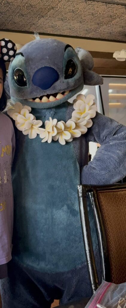 6-Day Disney World Family Trip Recap (With Budget Tips & Highlights) 3 Stitch character posing during ‘Ohana breakfast at Disney’s Polynesian Village Resort