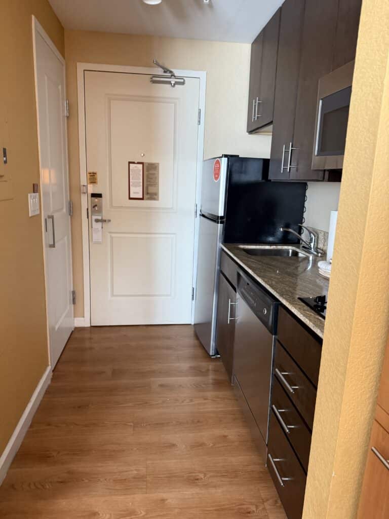Suite entryway and kitchenette view at TownePlace Suites Orlando Flamingo Crossings