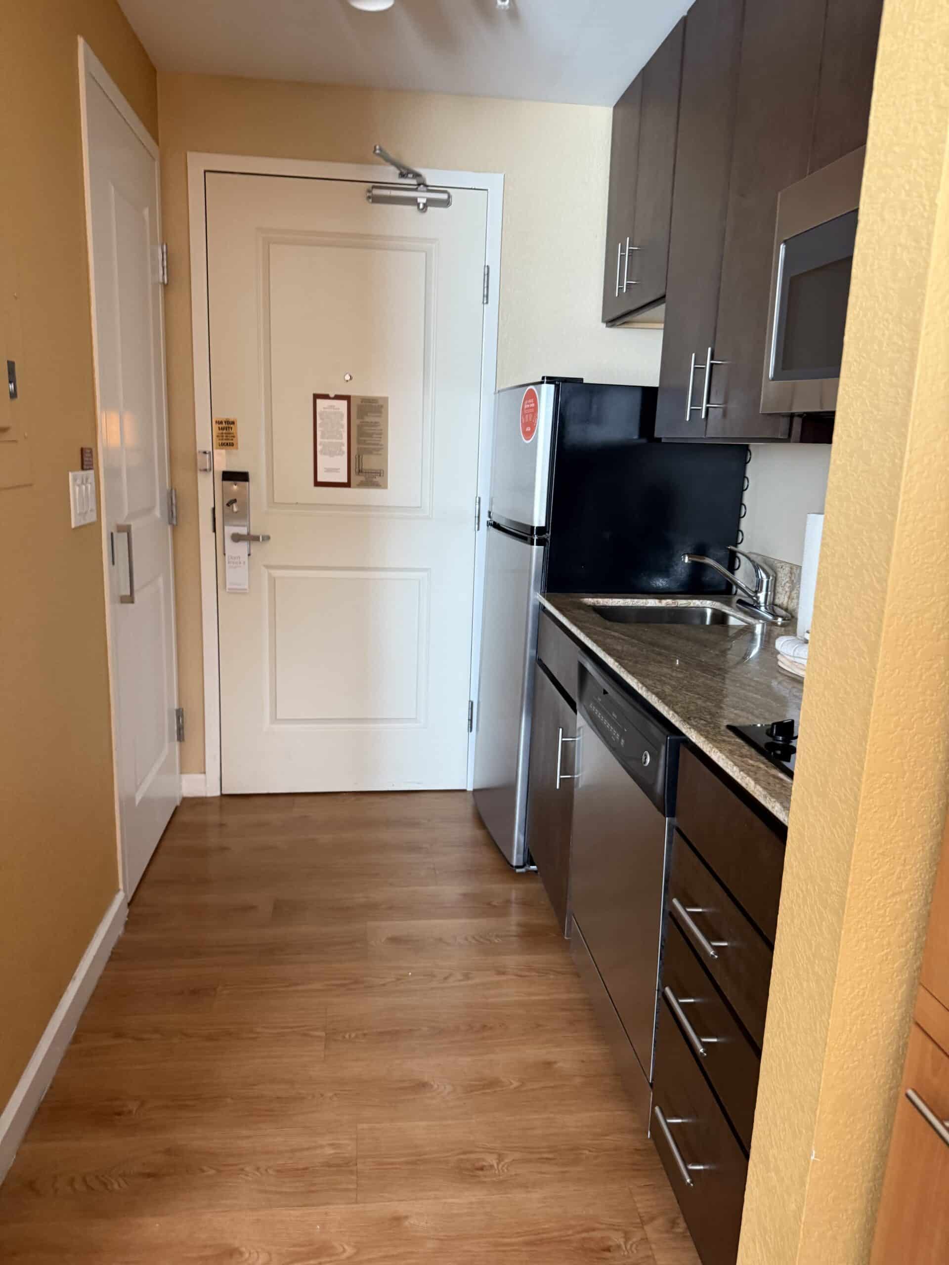 Suite entryway and kitchenette view at TownePlace Suites Orlando Flamingo Crossings