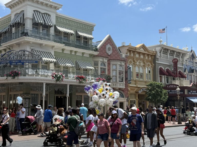 Main Street, U.S.A. with Disney balloons and guests at Magic Kingdom in Walt Disney World
