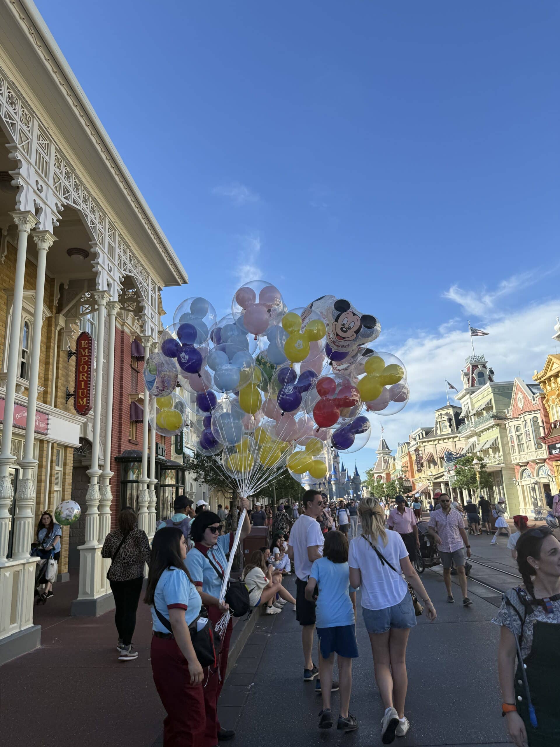 Main Street, U.S.A. with Disney balloons and guests at Magic Kingdom in Walt Disney World