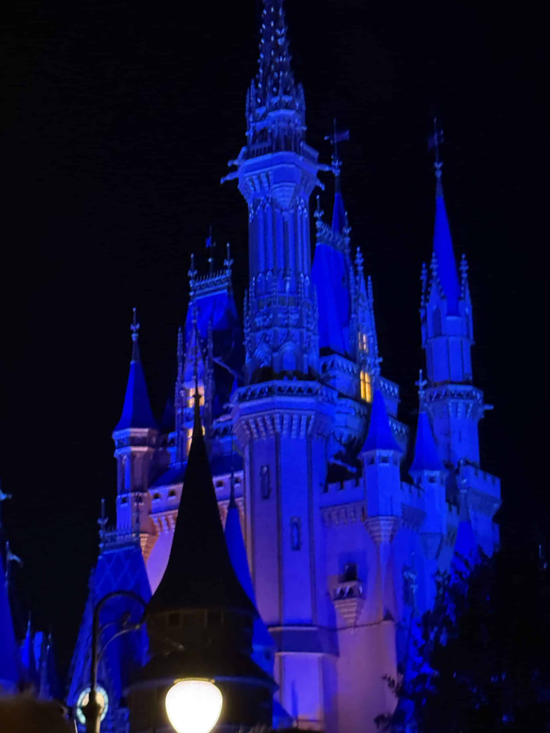 Cinderella Castle illuminated blue at night at Magic Kingdom in Walt Disney World