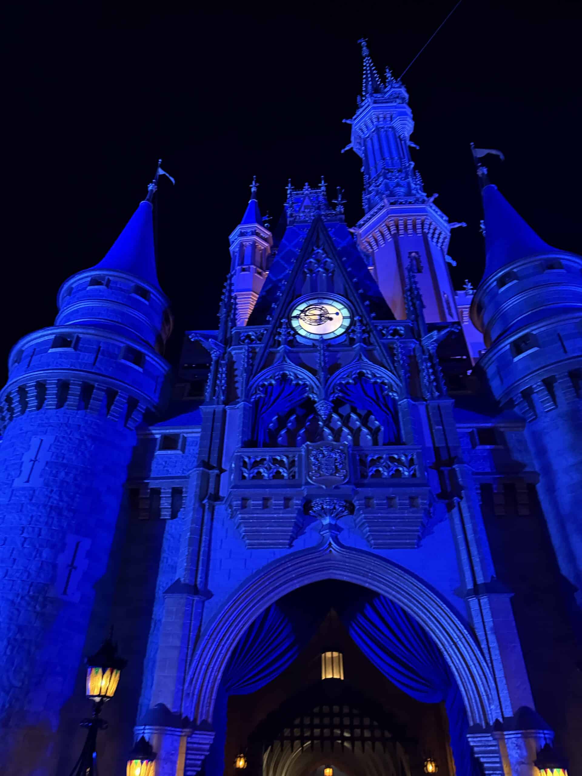 Cinderella Castle illuminated blue at night at Magic Kingdom in Walt Disney World