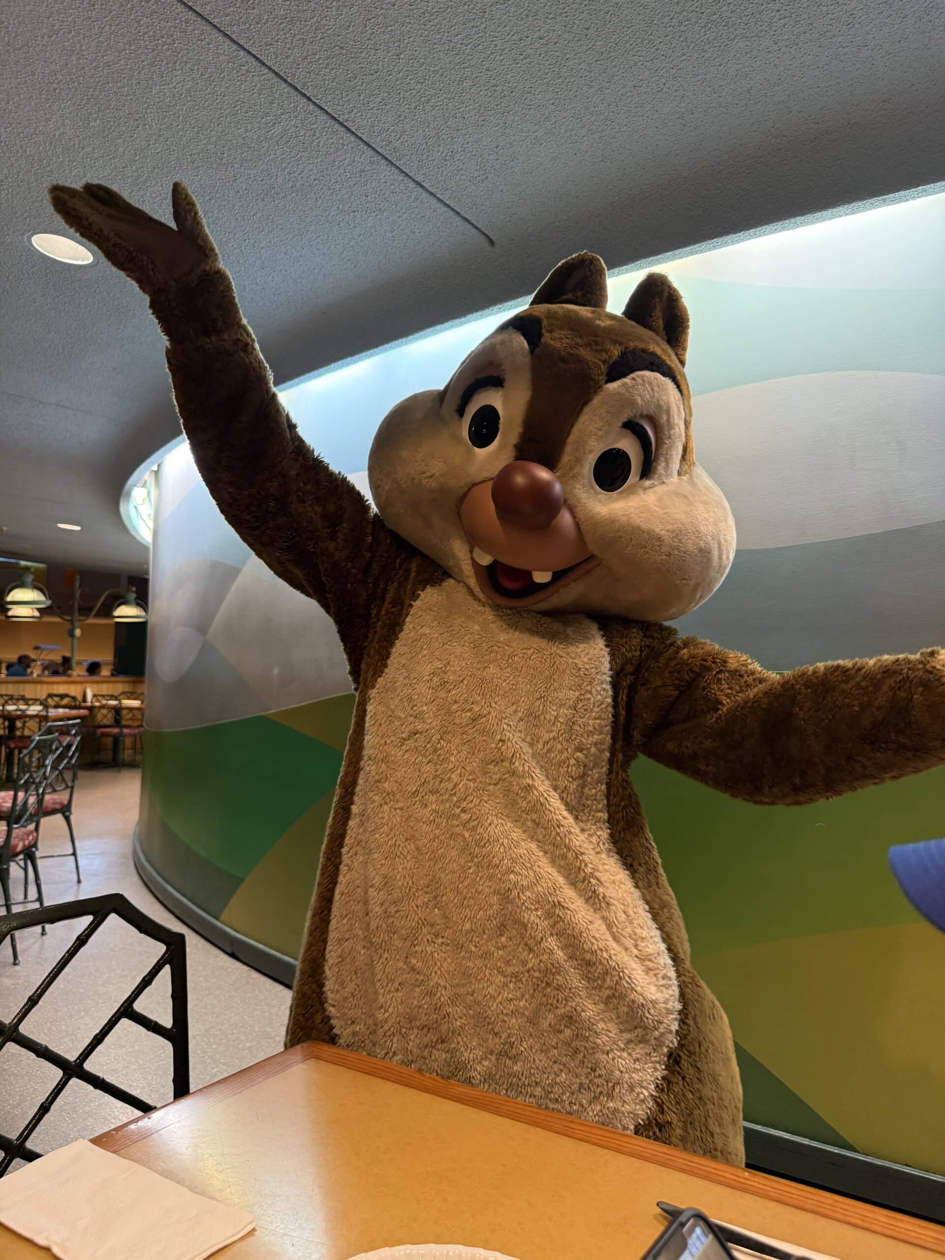 Chip character greeting guests during Chip ‘n’ Dale’s Harvest Feast at Garden Grill Restaurant in EPCOT at Walt Disney World.