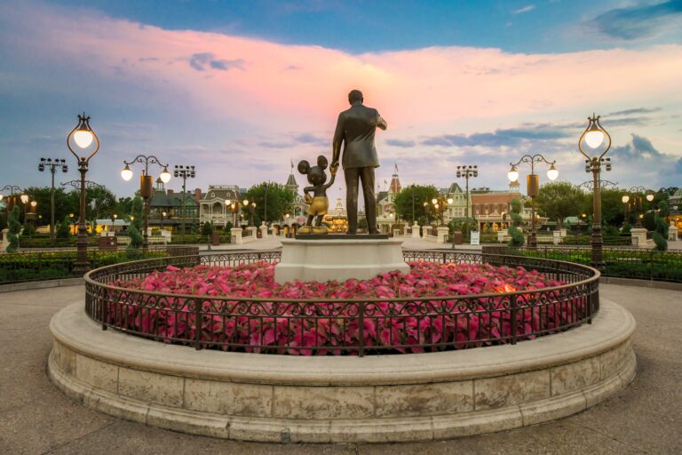Walt Disney statue with flower garden at EPCOT entrance at Walt Disney World