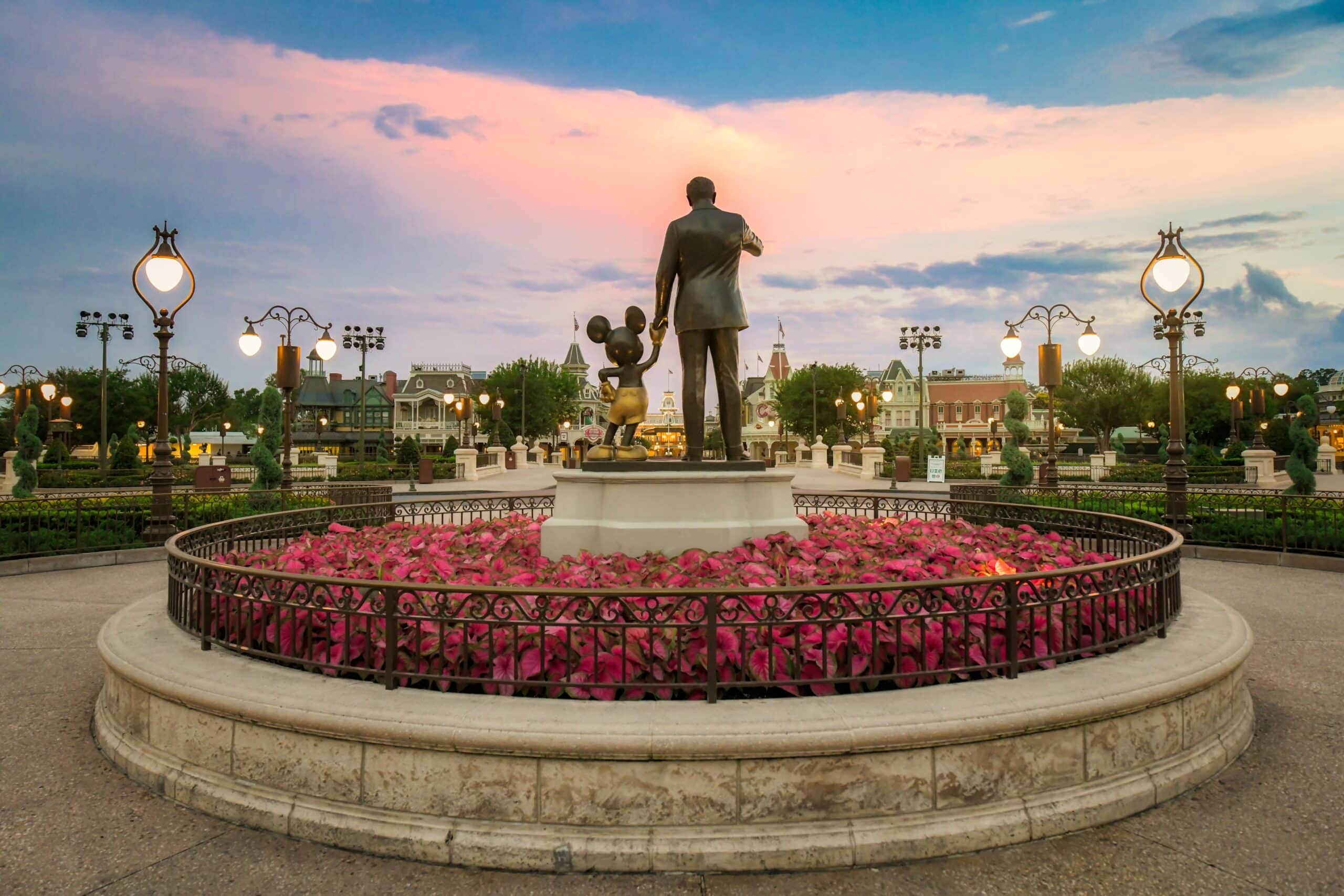 Walt Disney statue with flower garden at EPCOT entrance at Walt Disney World