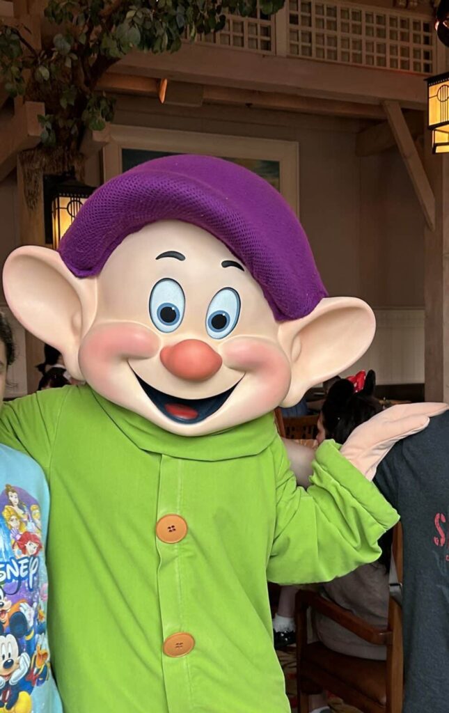 Animal Kingdom Review: Enchanting Extras + Storybook Dining 7 Dopey character at Storybook Dining at Artist Point with Snow White at Disney World